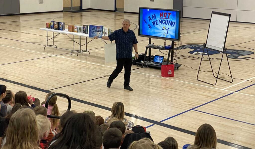 Timothy Young presents in a middle school gym in Elko, Nevada